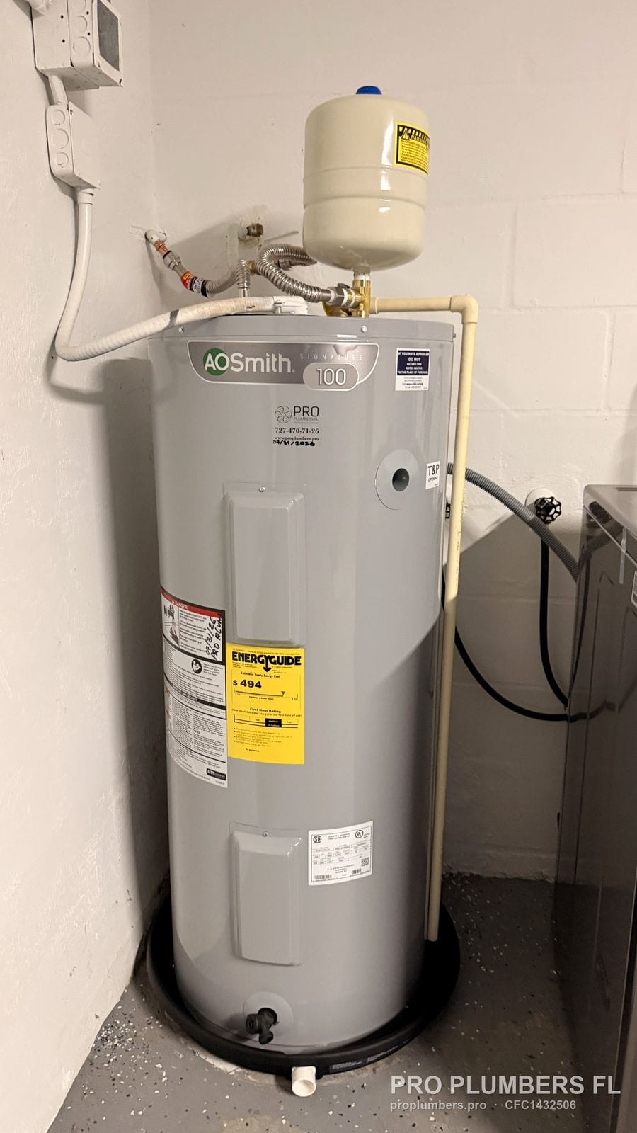 A.O. Smith electric tank water heater with expansion tank in a drain pan in Largo, Florida by PRO PLUMBERS FL, LLC (licence CFC1432506)