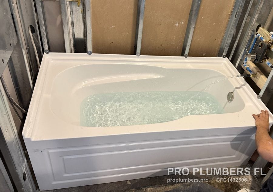 New alcove bathtub filled for a leak test in metal-stud framing in Tampa, Florida by PRO PLUMBERS FL, LLC (licence CFC1432506)