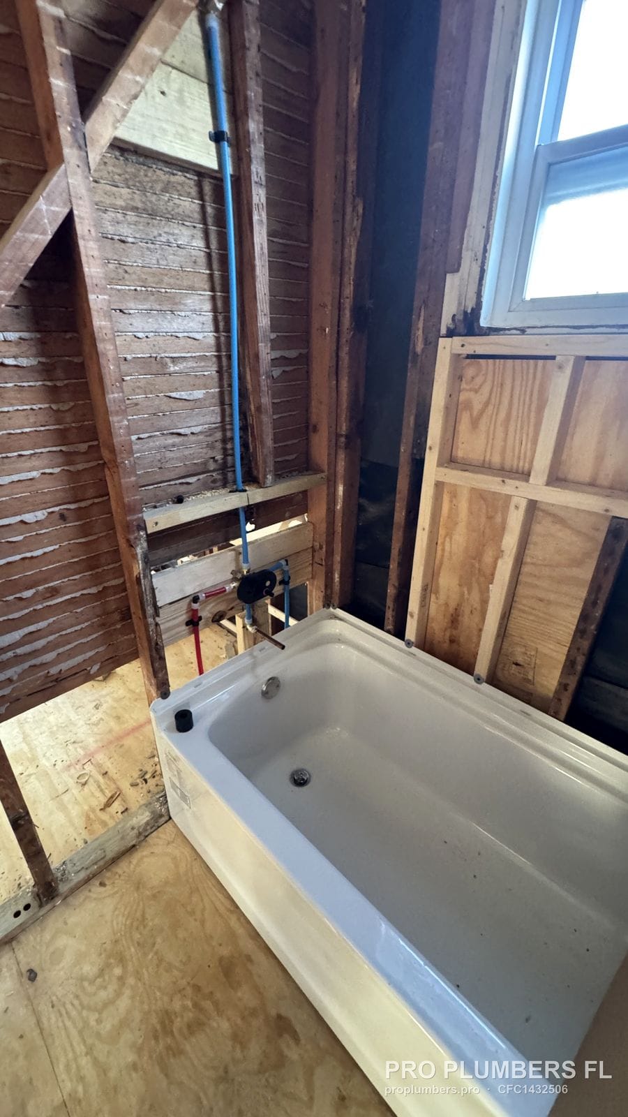 Alcove bathtub set in place with the tub and shower valve roughed in behind it in St. Petersburg, Florida by PRO PLUMBERS FL, LLC (licence CFC1432506)