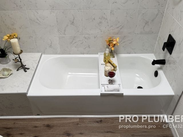 Finished bathtub with matte black valve trim and spout in Pinellas Park, Florida by PRO PLUMBERS FL, LLC (licence CFC1432506)