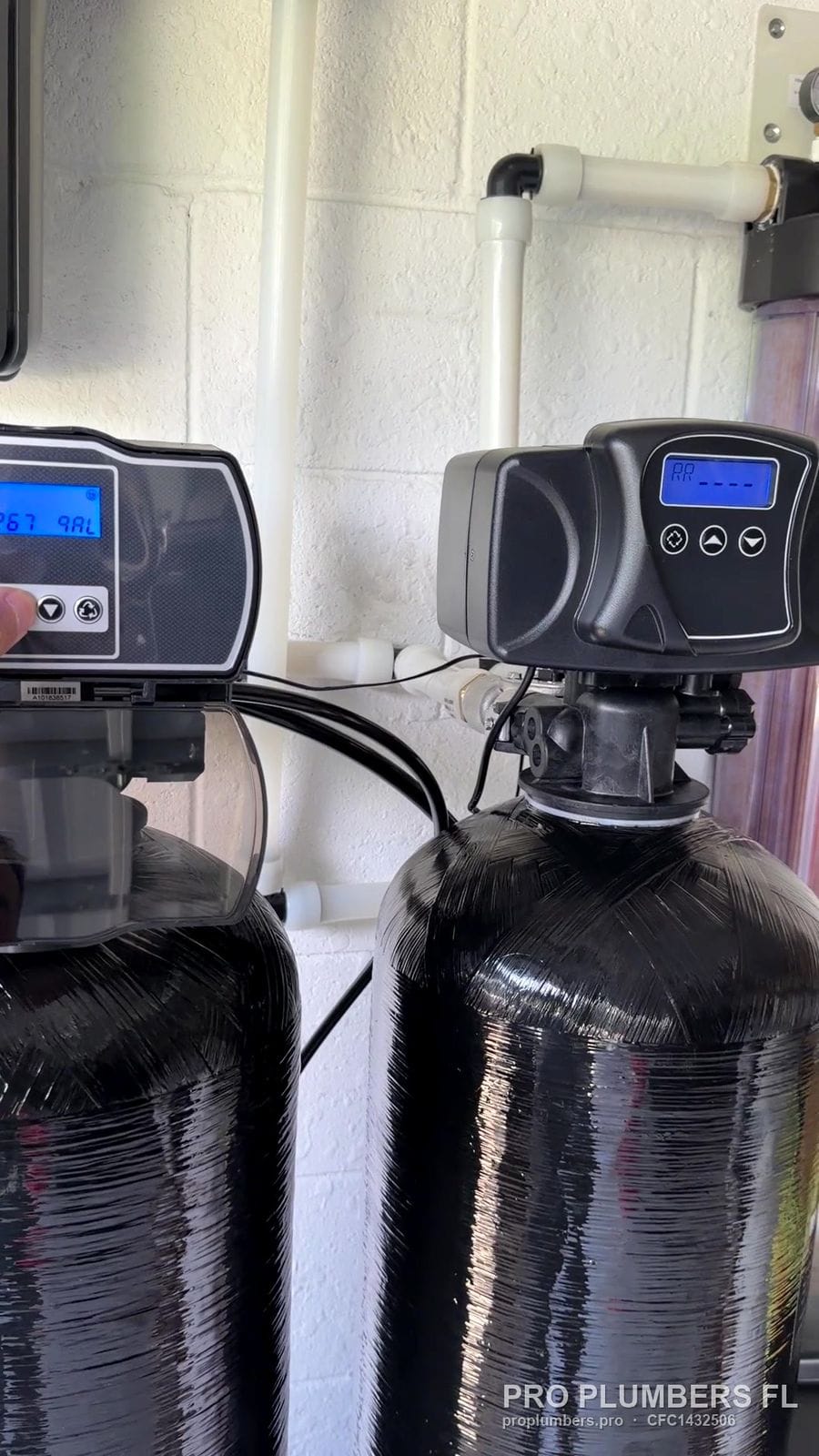 Digital control heads on twin water treatment tanks in Bradenton, Florida by PRO PLUMBERS FL, LLC (licence CFC1432506)