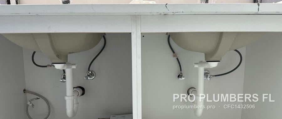 Double vanity cabinet with two new PVC P-trap drains and braided supply lines in Clearwater, Florida by PRO PLUMBERS FL, LLC (licence CFC1432506)