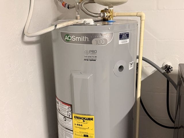 Electric tank water heater in a drain pan with thermal expansion tank and shutoff valve in Largo, Florida by PRO PLUMBERS FL, LLC (licence CFC1432506)