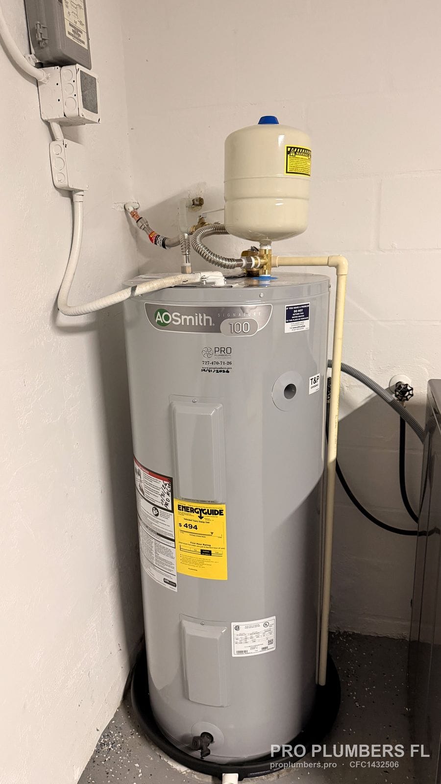 Electric tank water heater in a drain pan with thermal expansion tank and shutoff valve in Largo, Florida by PRO PLUMBERS FL, LLC (licence CFC1432506)