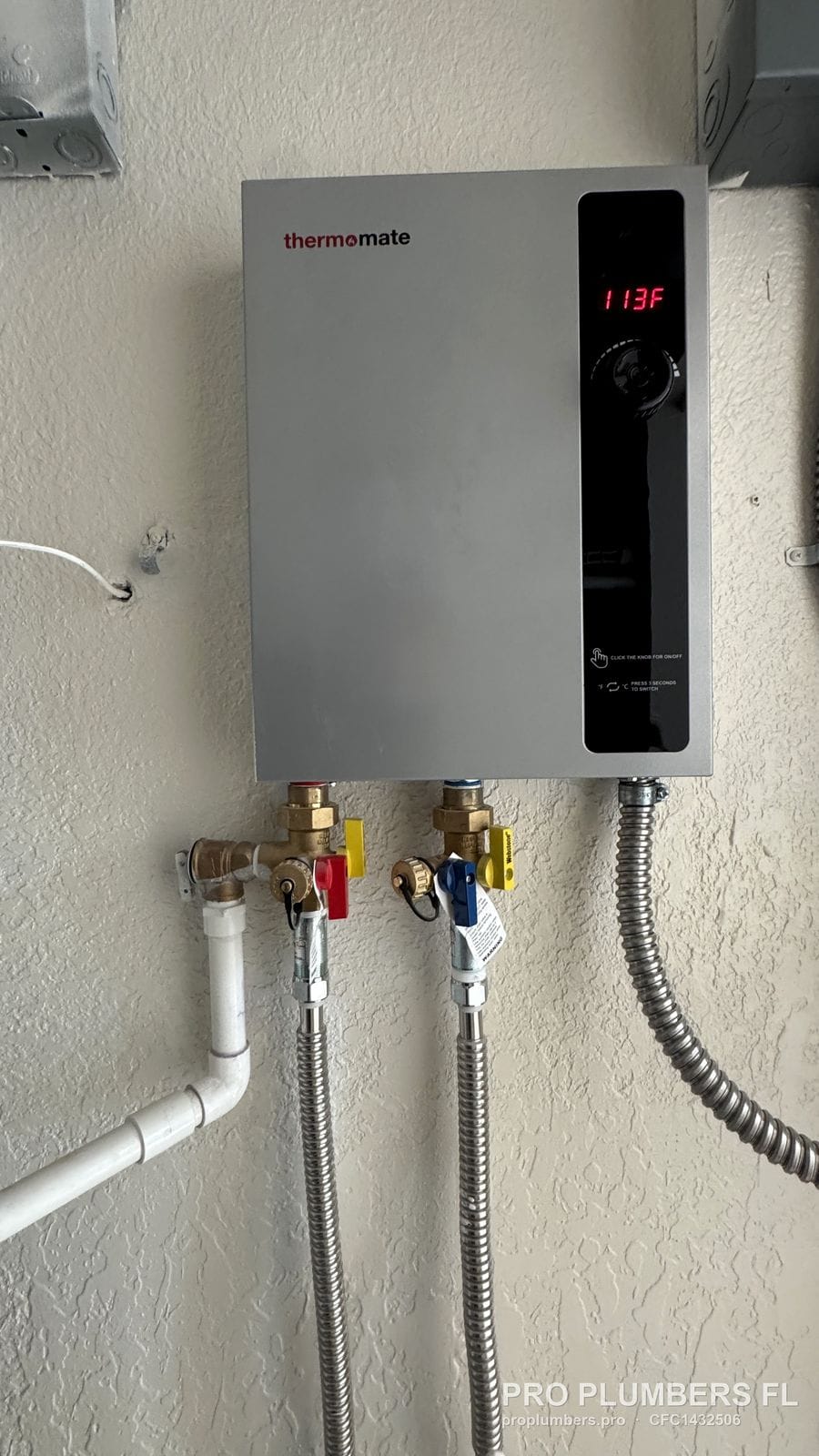 Electric tankless water heater display reading 113 F with isolation valves below in Treasure Island, Florida by PRO PLUMBERS FL, LLC (licence CFC1432506)