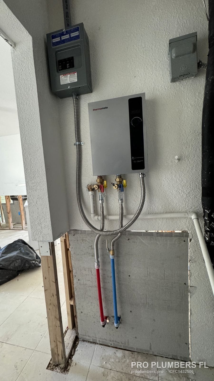 Electric tankless water heater and subpanel installed while the lower wall is still open in Treasure Island, Florida by PRO PLUMBERS FL, LLC (licence CFC1432506)