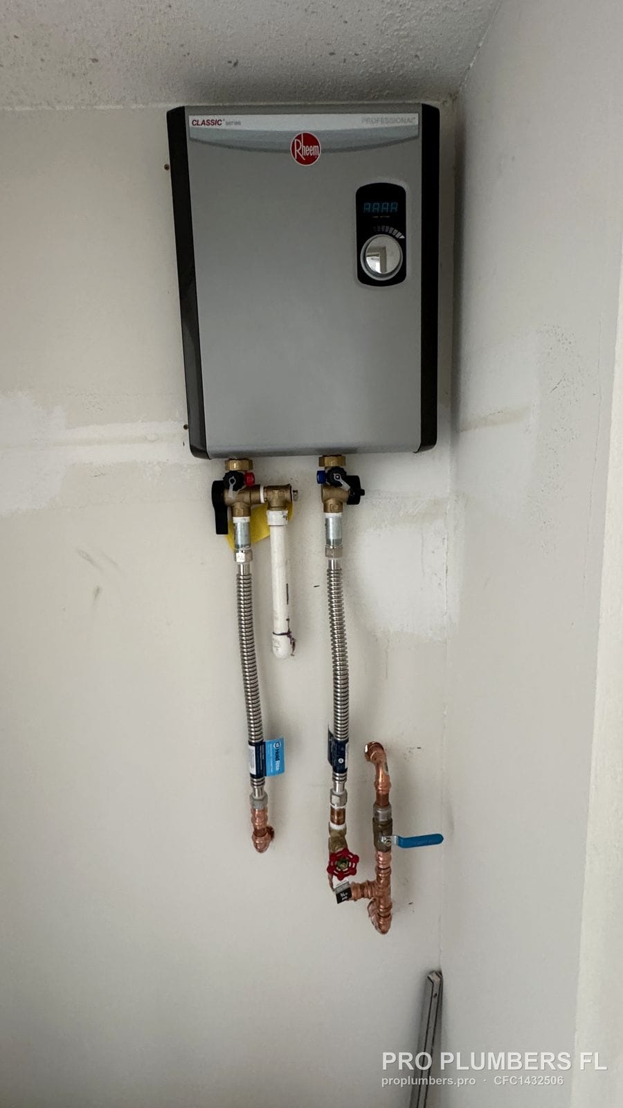 Wall-mounted electric tankless water heater with isolation valve kit and braided connectors in Sarasota, Florida by PRO PLUMBERS FL, LLC (licence CFC1432506)