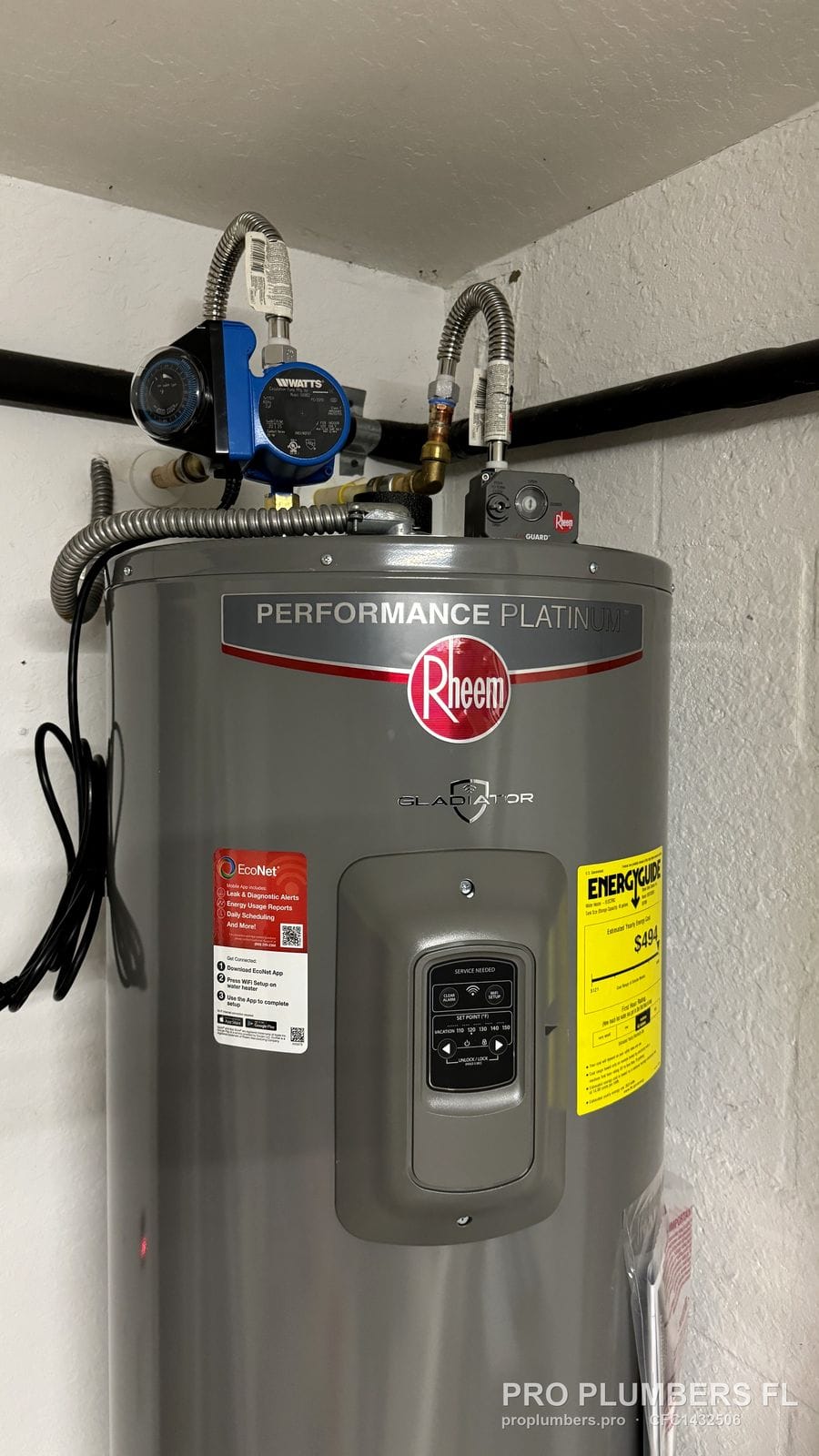 Top of an electric tank water heater with circulator pump and braided connectors in Venice, Florida by PRO PLUMBERS FL, LLC (licence CFC1432506)