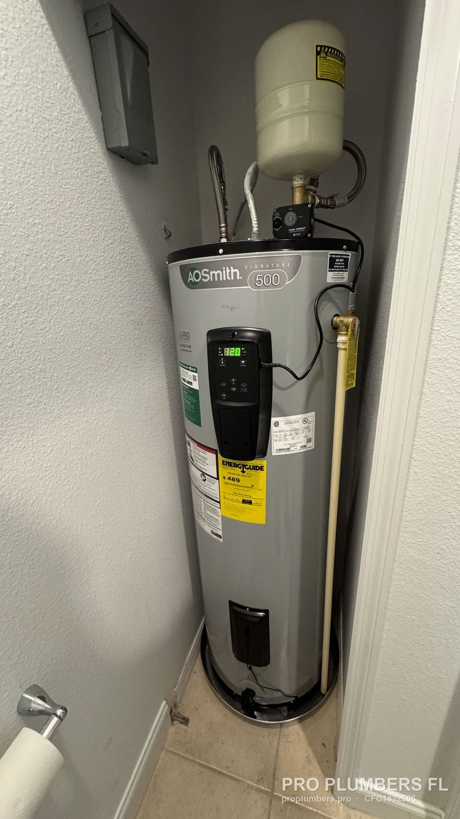 Electric tank water heater with expansion tank fitted into a narrow closet in Clearwater, Florida by PRO PLUMBERS FL, LLC (licence CFC1432506)