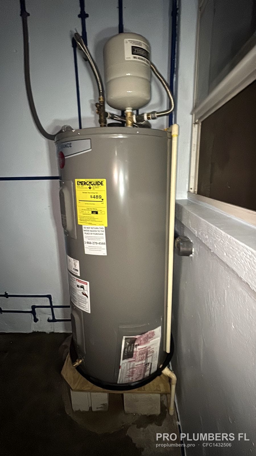 Electric tank water heater on a raised platform with expansion tank and PEX piping in St. Pete Beach, Florida by PRO PLUMBERS FL, LLC (licence CFC1432506)