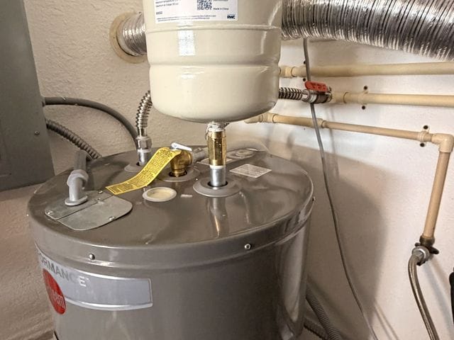Electric tank water heater with expansion tank in a utility room in St. Petersburg, Florida by PRO PLUMBERS FL, LLC (licence CFC1432506)