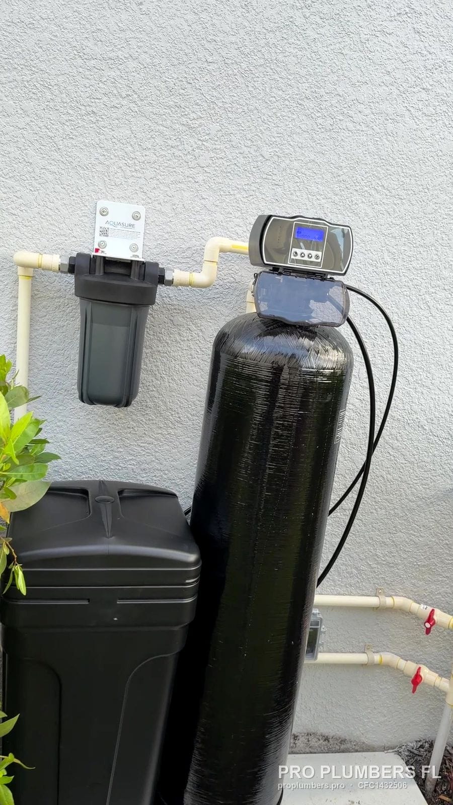 Exterior water softener with prefilter and brine tank on a concrete pad in Sarasota, Florida by PRO PLUMBERS FL, LLC (licence CFC1432506)