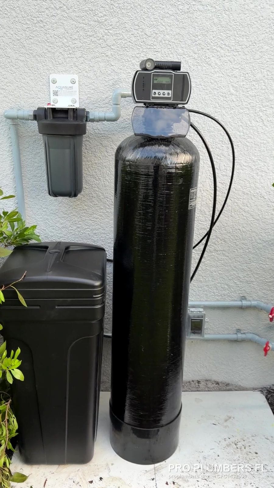 Exterior water softener with prefilter on a stucco wall in Sarasota, Florida by PRO PLUMBERS FL, LLC (licence CFC1432506)