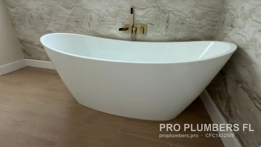 Freestanding slipper tub under a brushed gold wall-mounted filler in Clearwater, Florida by PRO PLUMBERS FL, LLC (licence CFC1432506)