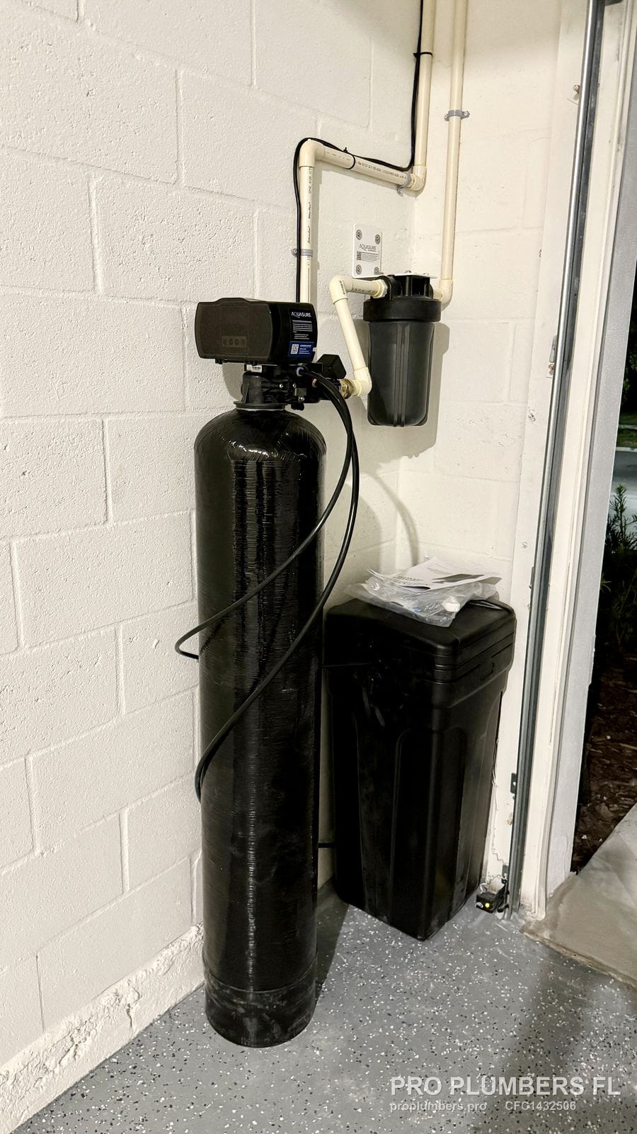 Garage water softener installation with sediment prefilter and CPVC drop from the ceiling in Wesley Chapel, Florida by PRO PLUMBERS FL, LLC (licence CFC1432506)