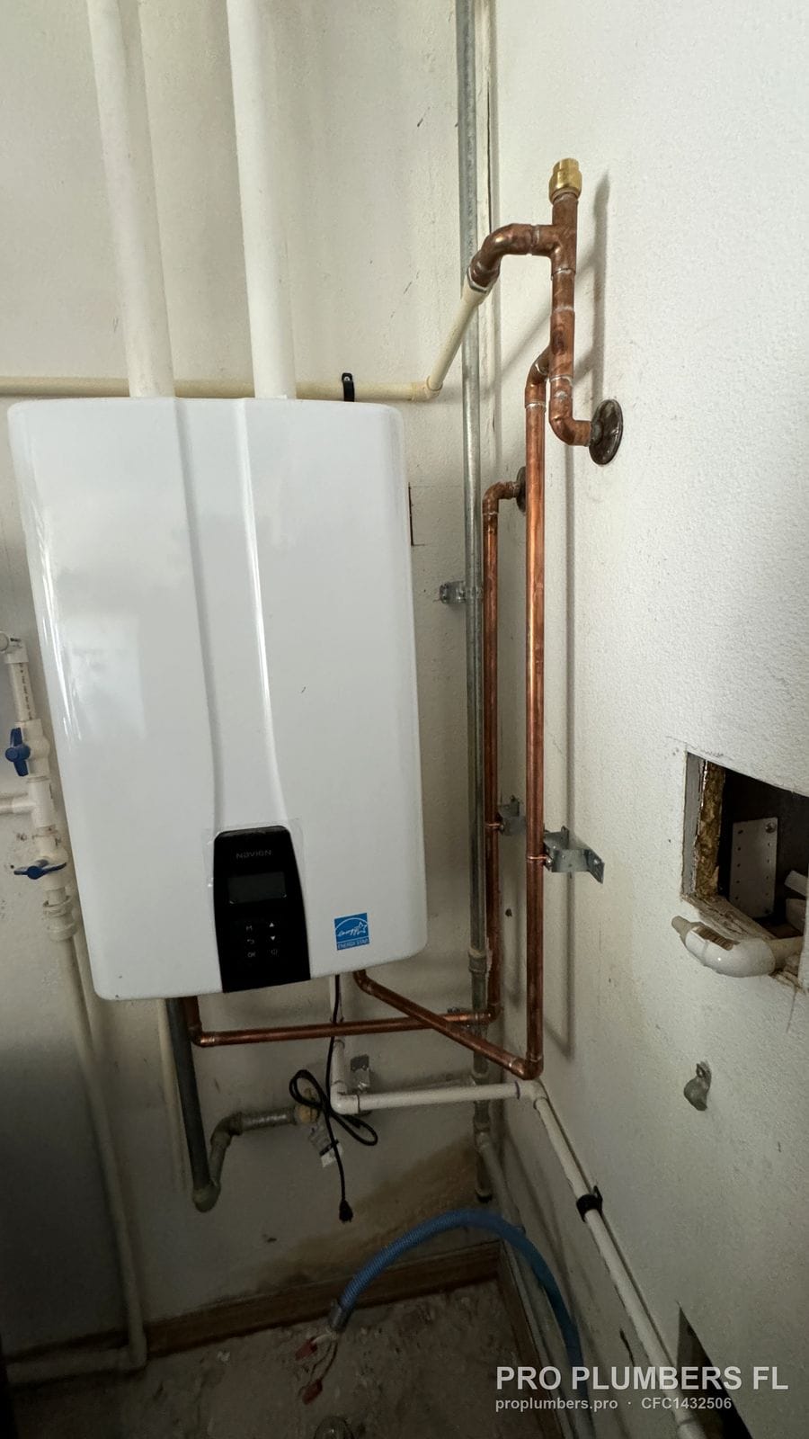 Gas tankless water heater with copper risers routed up the wall in Largo, Florida by PRO PLUMBERS FL, LLC (licence CFC1432506)