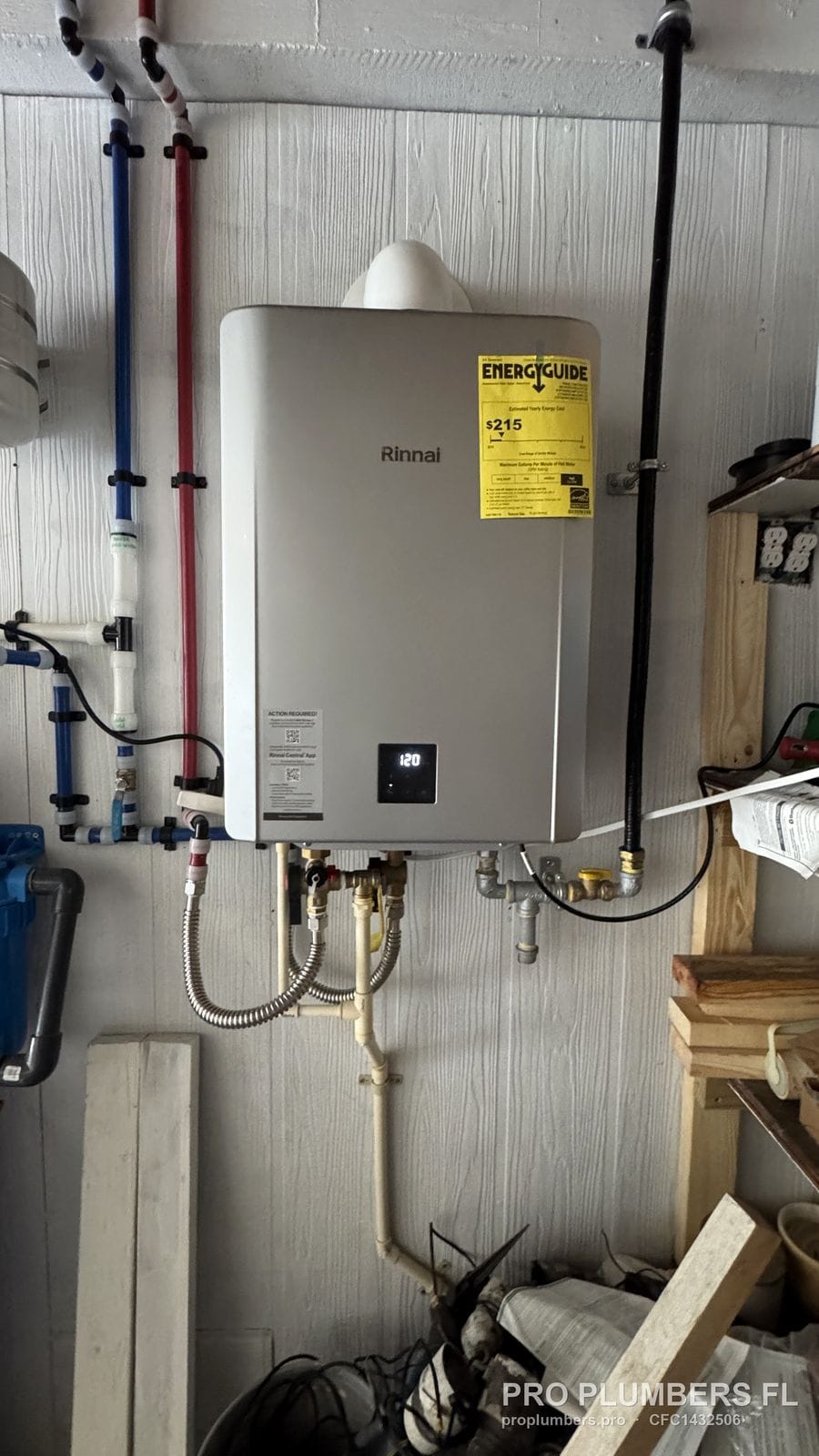 Wall-mounted gas tankless water heater with PVC venting and PEX lines in a utility room in Englewood, Florida by PRO PLUMBERS FL, LLC (licence CFC1432506)