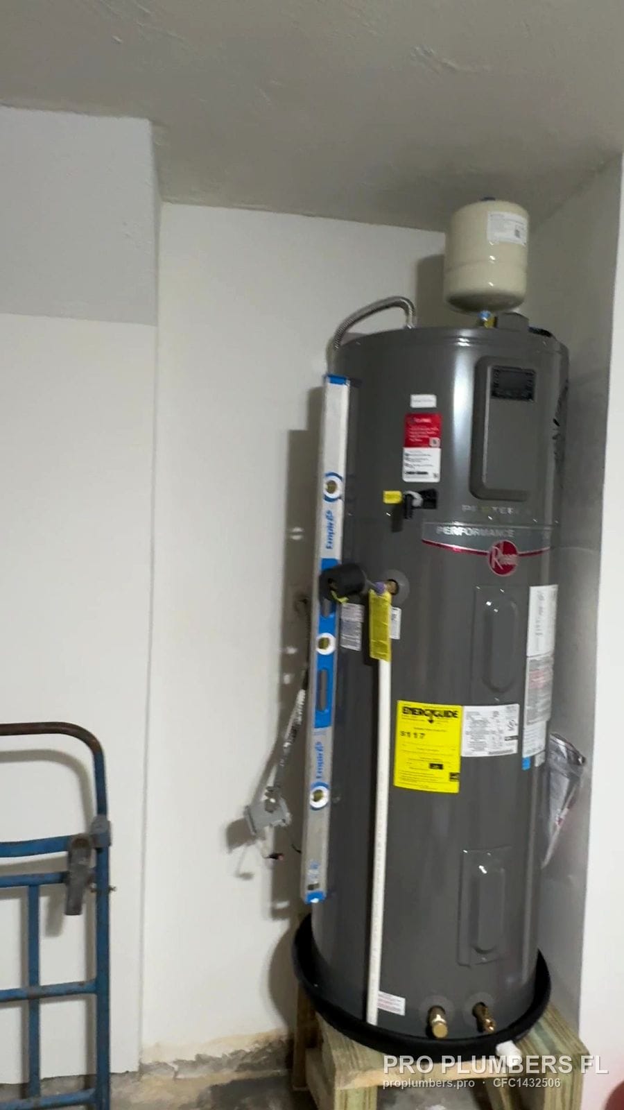 Heat pump water heater with expansion tank on a raised wooden stand and drain pan in Belleair Beach, Florida by PRO PLUMBERS FL, LLC (licence CFC1432506)