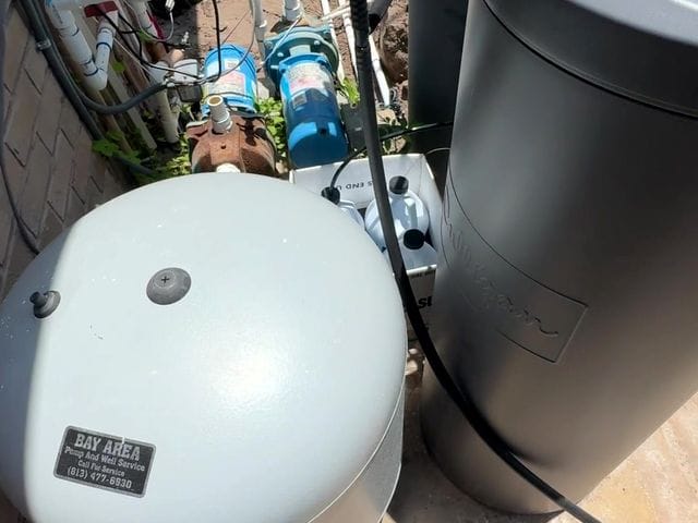 Irrigation pump and pressure tank at the house wall in Ruskin, Florida by PRO PLUMBERS FL, LLC (licence CFC1432506)