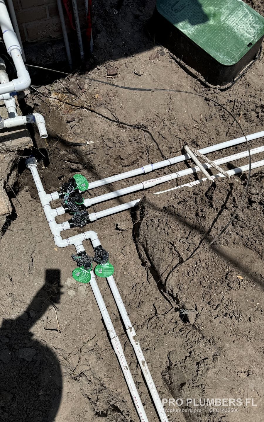 Irrigation PVC manifold with five solenoid valves set in the ground before backfill in Ruskin, Florida by PRO PLUMBERS FL, LLC (licence CFC1432506)
