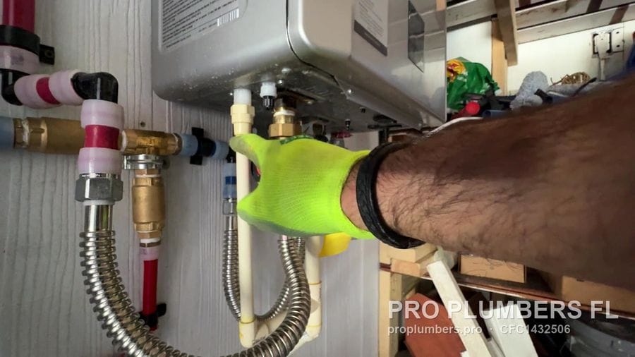Isolation valves and flex connectors under a gas tankless water heater in Englewood, Florida by PRO PLUMBERS FL, LLC (licence CFC1432506)