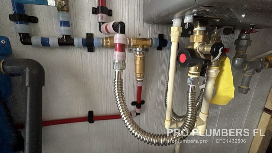 Isolation valves PEX lines and gas shutoff under a tankless water heater in Englewood, Florida by PRO PLUMBERS FL, LLC (licence CFC1432506)