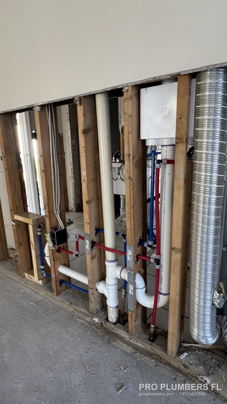 PVC laundry drain and PEX supply rough-in inside an open stud wall in Pinellas Park, Florida by PRO PLUMBERS FL, LLC (licence CFC1432506)