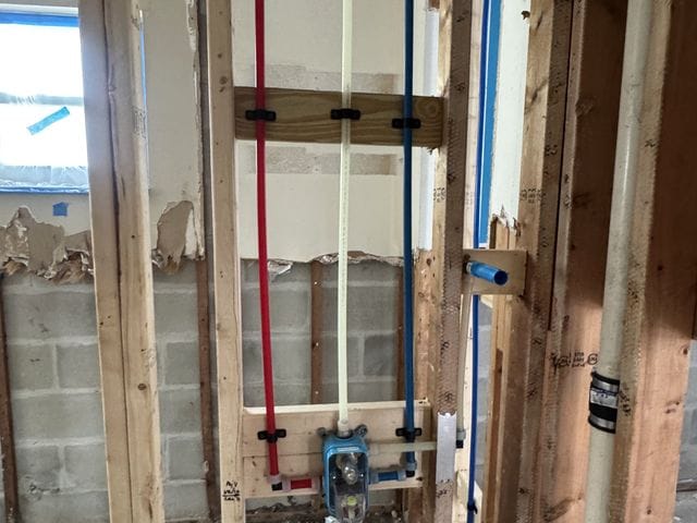 Shower rough-in with PEX-A piping during a bathroom remodel against a block wall in Belleair Beach, Florida by PRO PLUMBERS FL, LLC (licence CFC1432506)