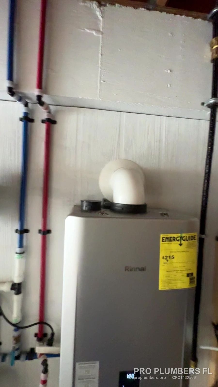 Rinnai gas tankless water heater with PVC vent elbow in Englewood, Florida by PRO PLUMBERS FL, LLC (licence CFC1432506)