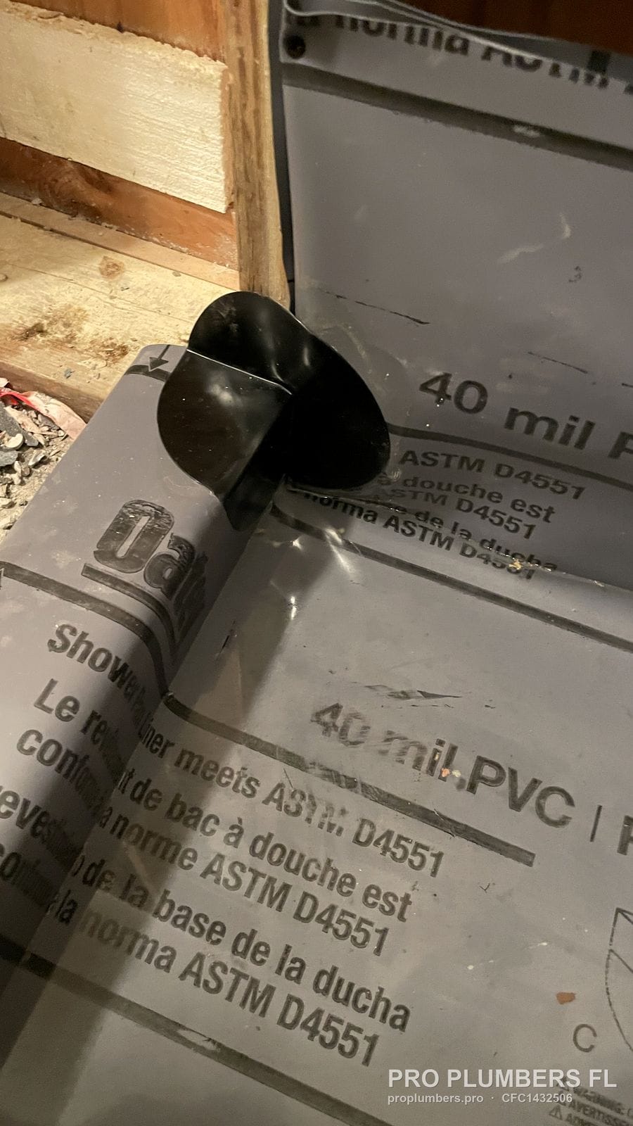 Pre-formed inside corner on a 40 mil PVC shower liner marked ASTM D4551 in Land O' Lakes, Florida by PRO PLUMBERS FL, LLC (licence CFC1432506)