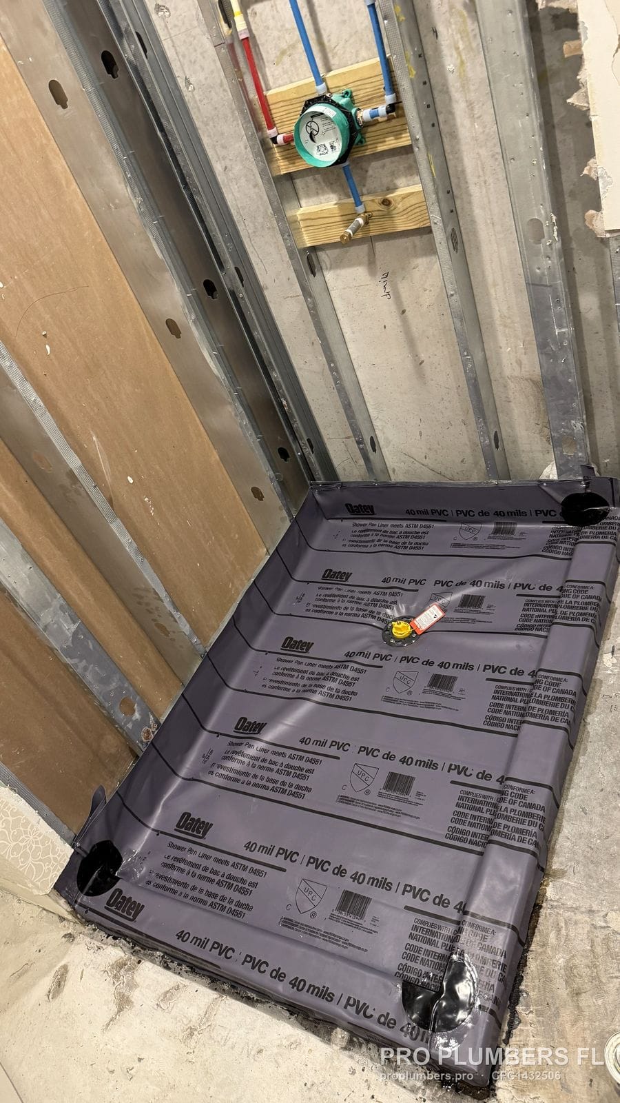 Shower pan liner with drain test plug and mixing valve rough-in above in Tampa, Florida by PRO PLUMBERS FL, LLC (licence CFC1432506)