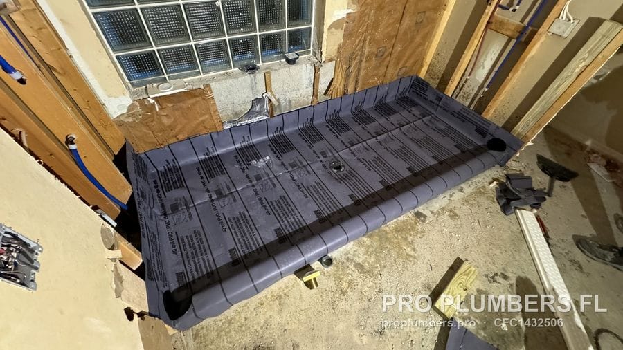 Shower pan liner with pre-formed corners and drain opening in a gutted bathroom in Sarasota, Florida by PRO PLUMBERS FL, LLC (licence CFC1432506)