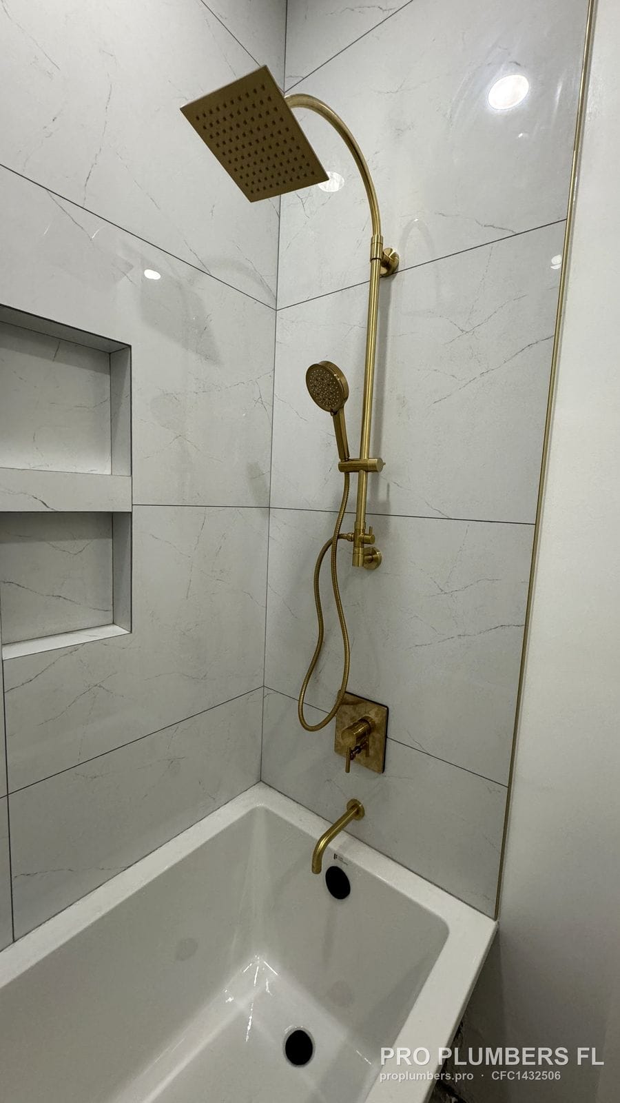 Brushed gold shower column with rain head, handheld and tub trim installed in Tampa, Florida by PRO PLUMBERS FL, LLC (licence CFC1432506)