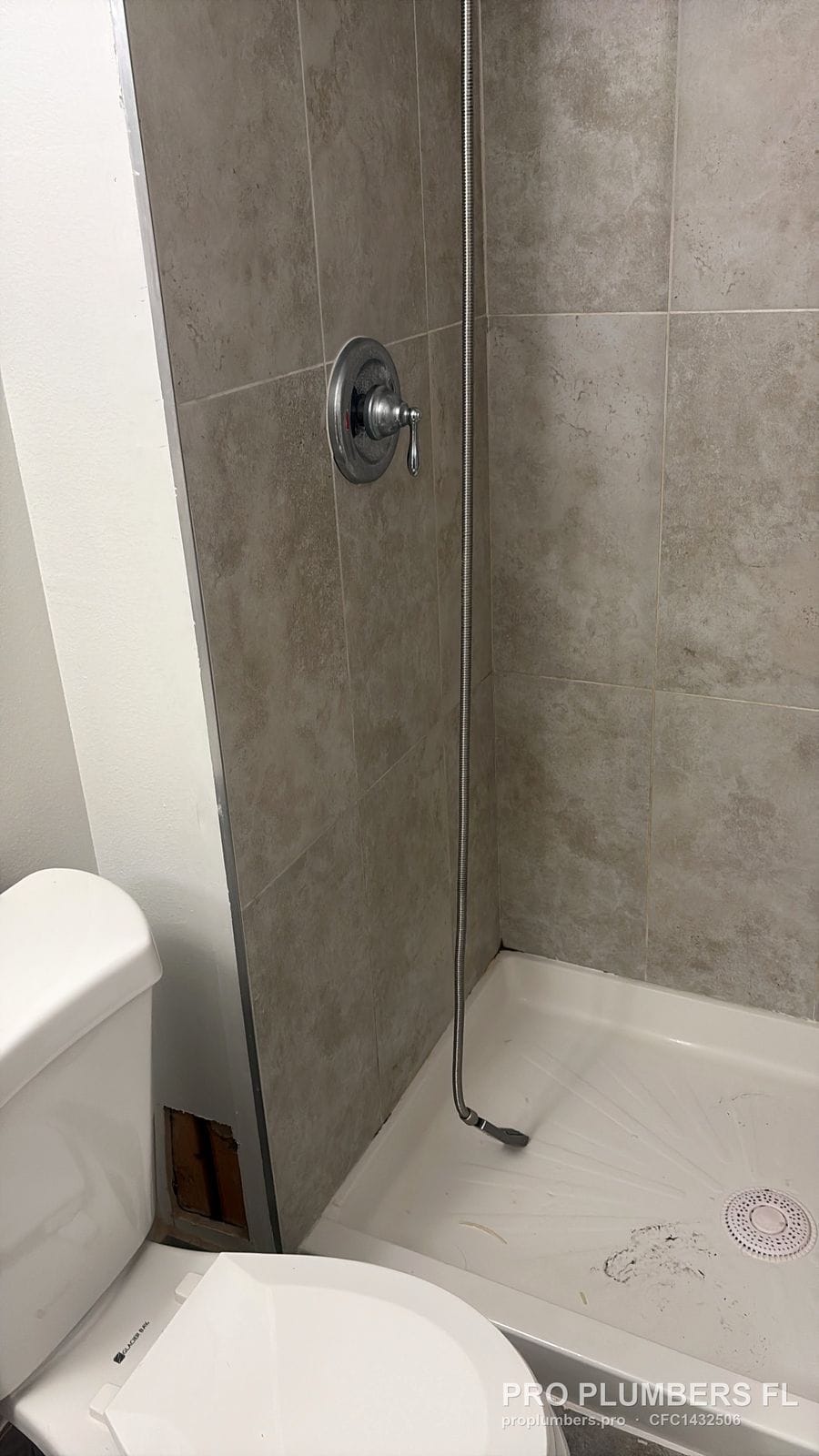 Chrome single-handle shower trim over a new shower base in Clearwater, Florida by PRO PLUMBERS FL, LLC (licence CFC1432506)