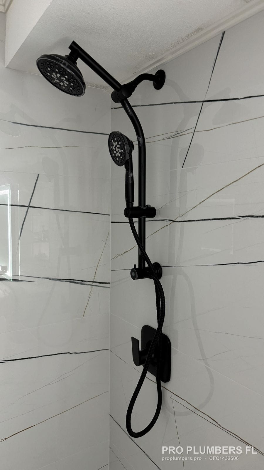 Matte black dual shower head with handheld and valve trim installed in Clearwater, Florida by PRO PLUMBERS FL, LLC (licence CFC1432506)