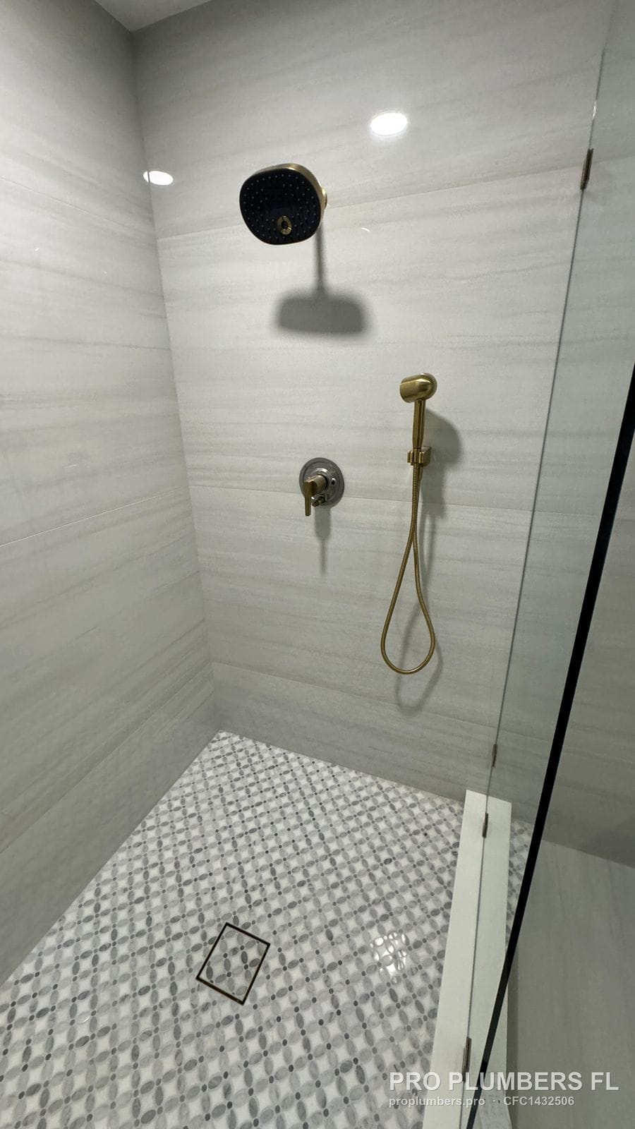 Shower valve trim and handheld over a mosaic shower floor in Largo, Florida by PRO PLUMBERS FL, LLC (licence CFC1432506)