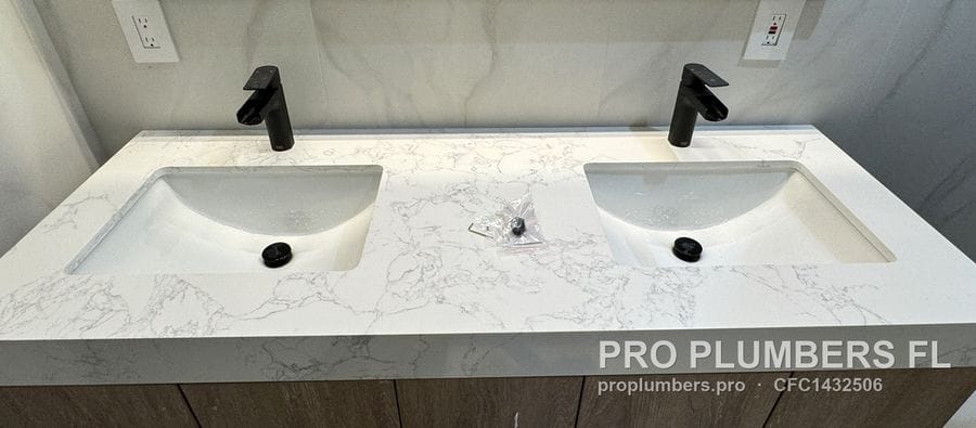 Double undermount quartz vanity with matte black faucets and drains in Venice, Florida by PRO PLUMBERS FL, LLC (licence CFC1432506)