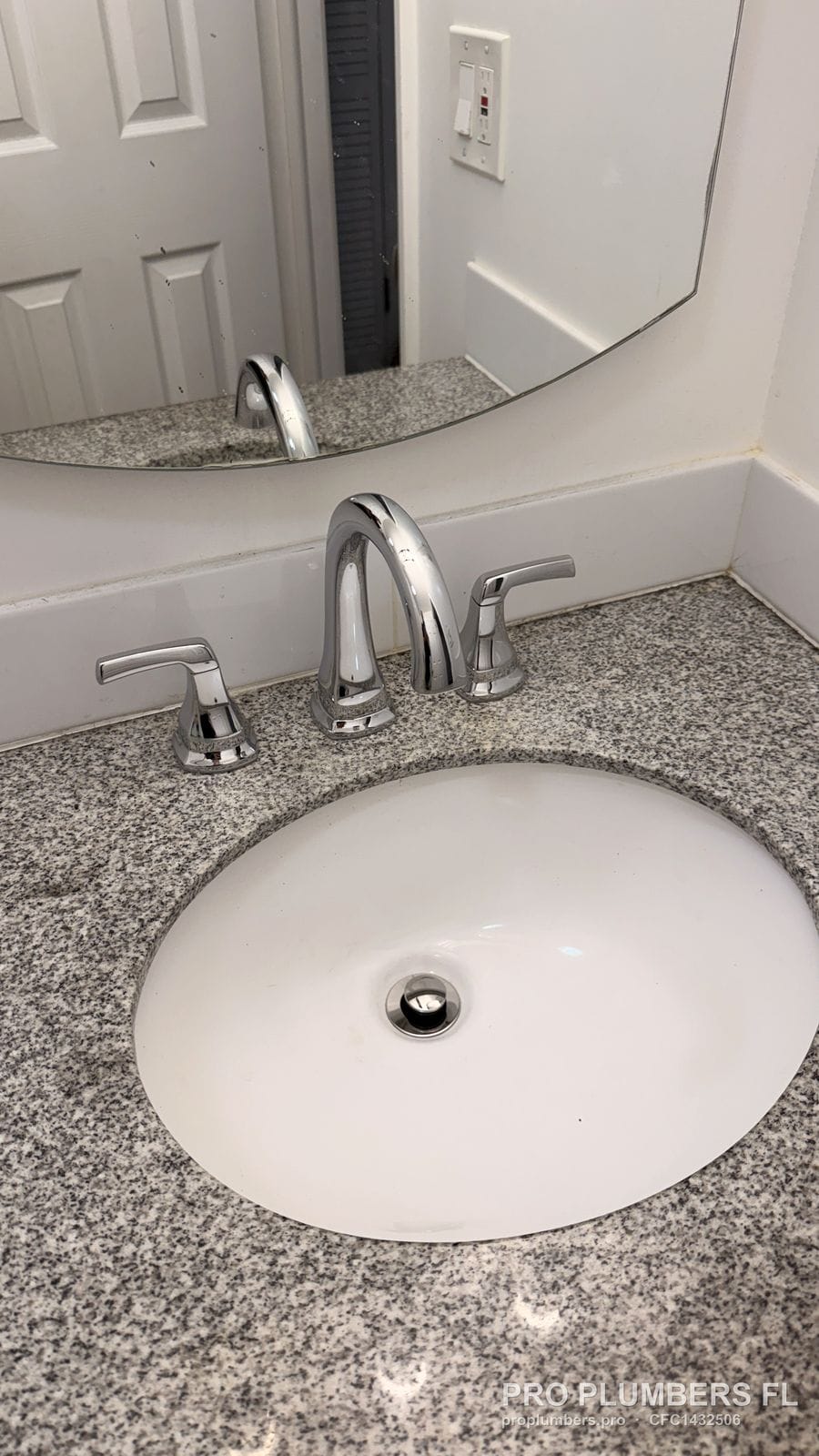 Tall chrome widespread faucet hitting the mirror line on a granite vanity in Largo, Florida by PRO PLUMBERS FL, LLC (licence CFC1432506)
