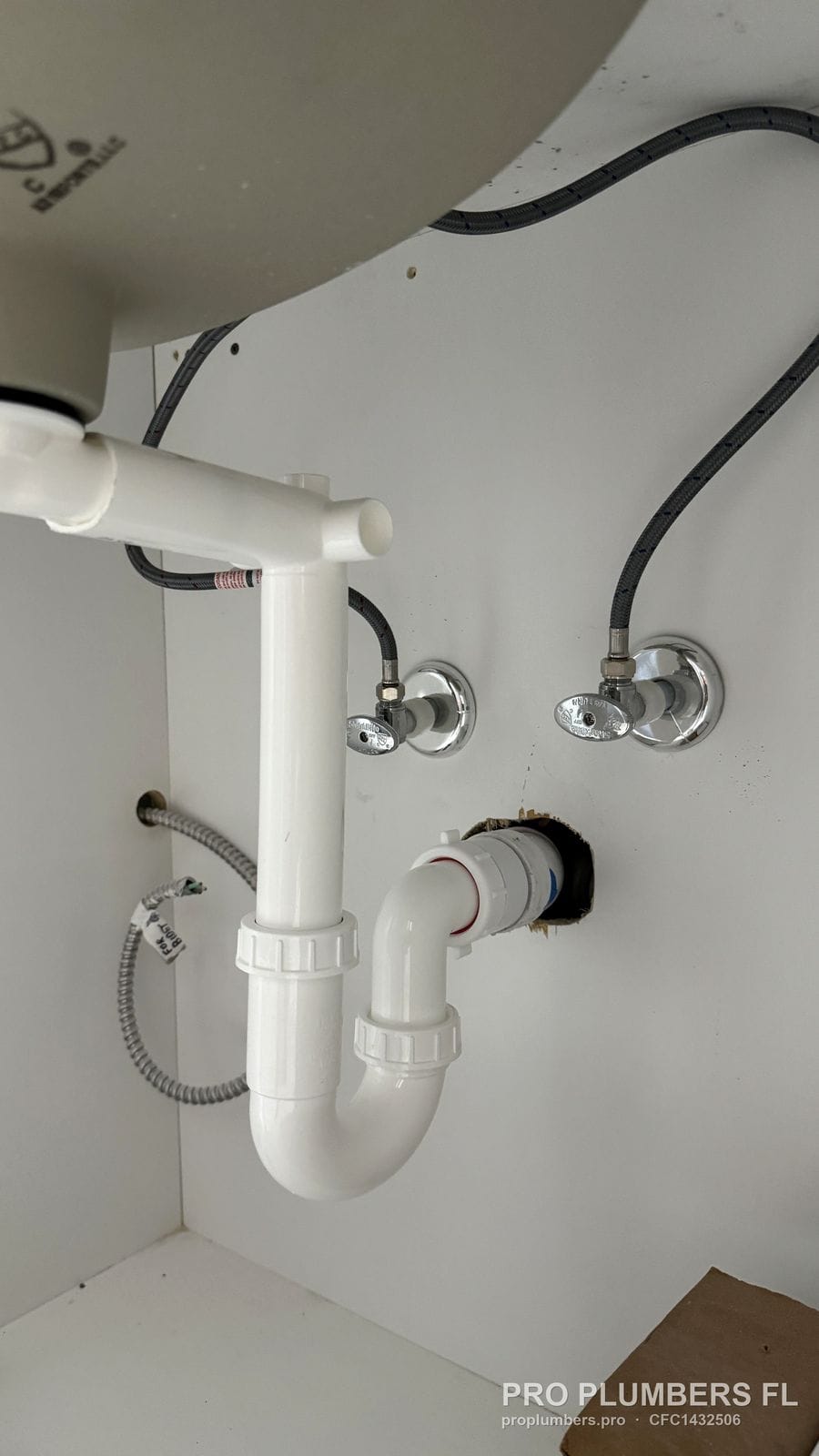 PVC P-trap, tailpiece and angle stop valves under a bathroom sink in Clearwater, Florida by PRO PLUMBERS FL, LLC (licence CFC1432506)
