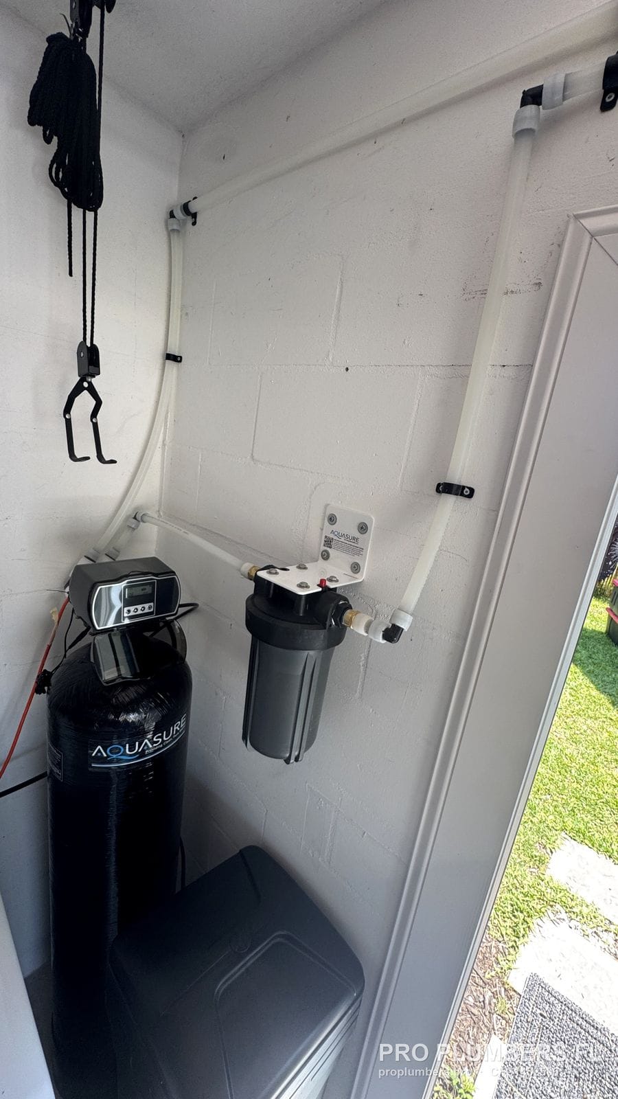 Water softener control head, prefilter on wall bracket and CPVC piping in a utility closet in South Pasadena, Florida by PRO PLUMBERS FL, LLC (licence CFC1432506)
