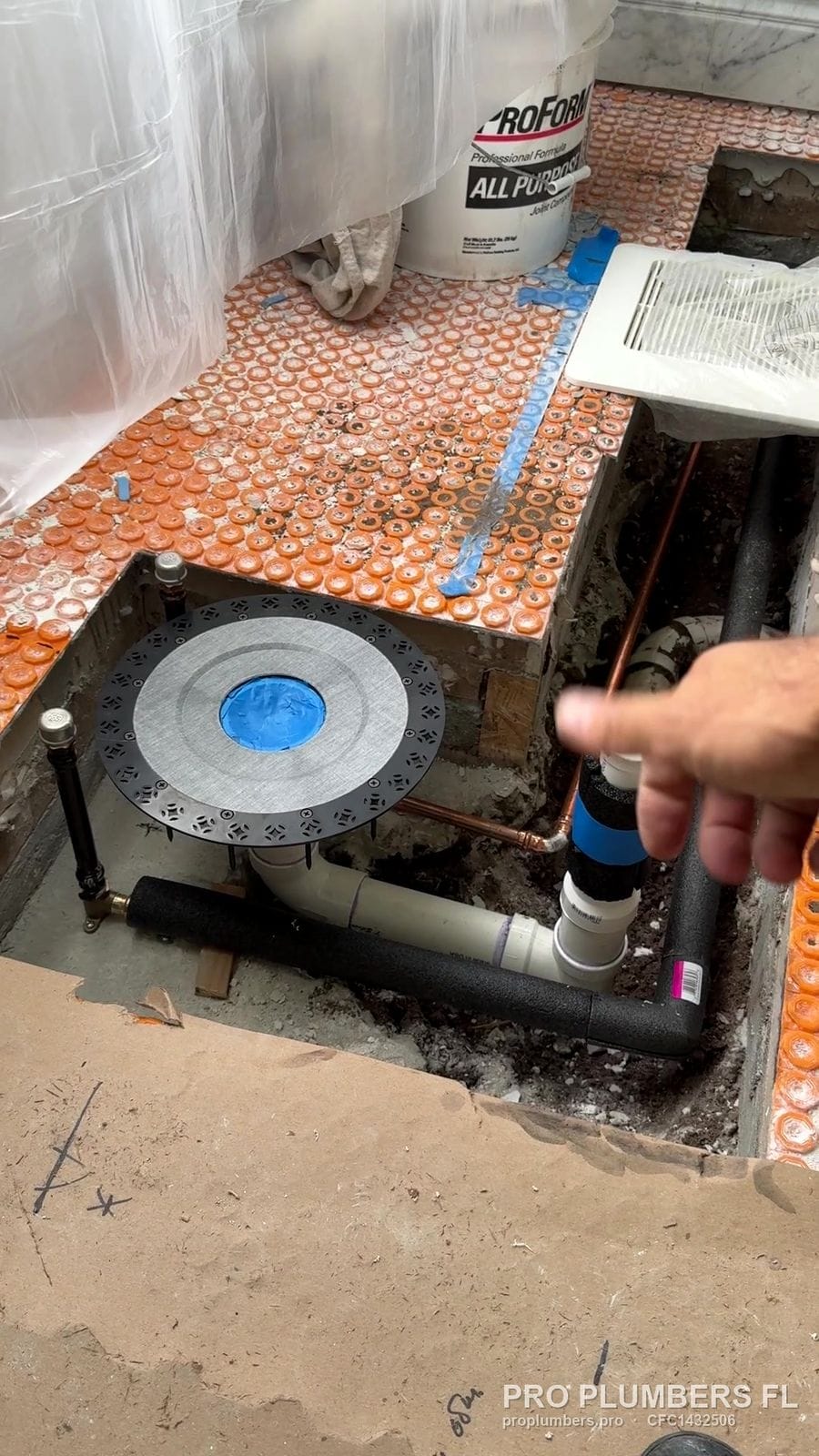 Tub filler and drain rough-in in an opened bathroom floor in East Lake, Florida by PRO PLUMBERS FL, LLC (licence CFC1432506)