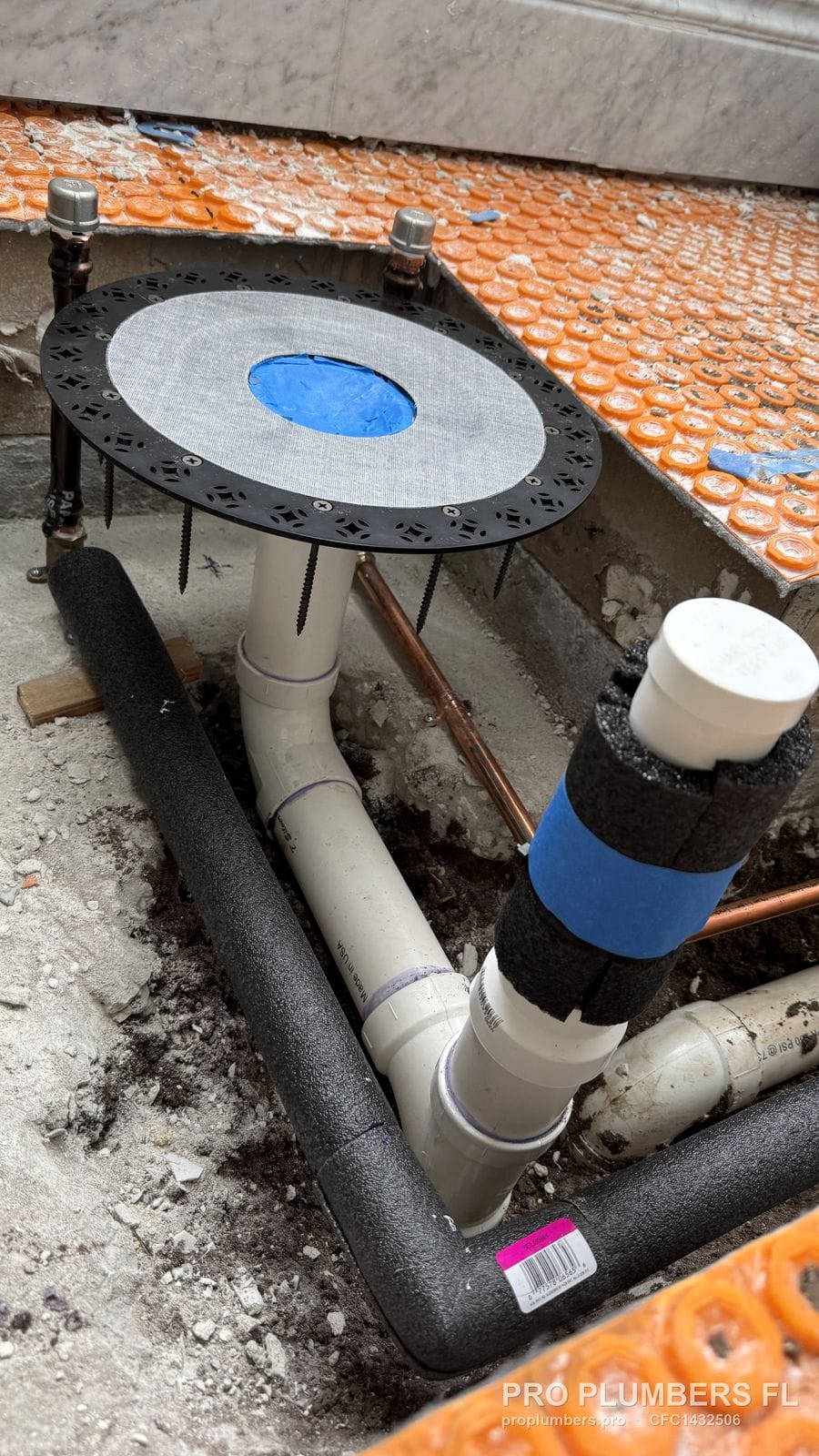 Tub filler rough-in plate with PVC drain riser and insulated lines before tile in East Lake, Florida by PRO PLUMBERS FL, LLC (licence CFC1432506)