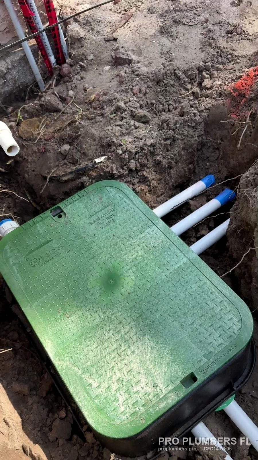 Valve box with PVC irrigation laterals in an open trench in Ruskin, Florida by PRO PLUMBERS FL, LLC (licence CFC1432506)