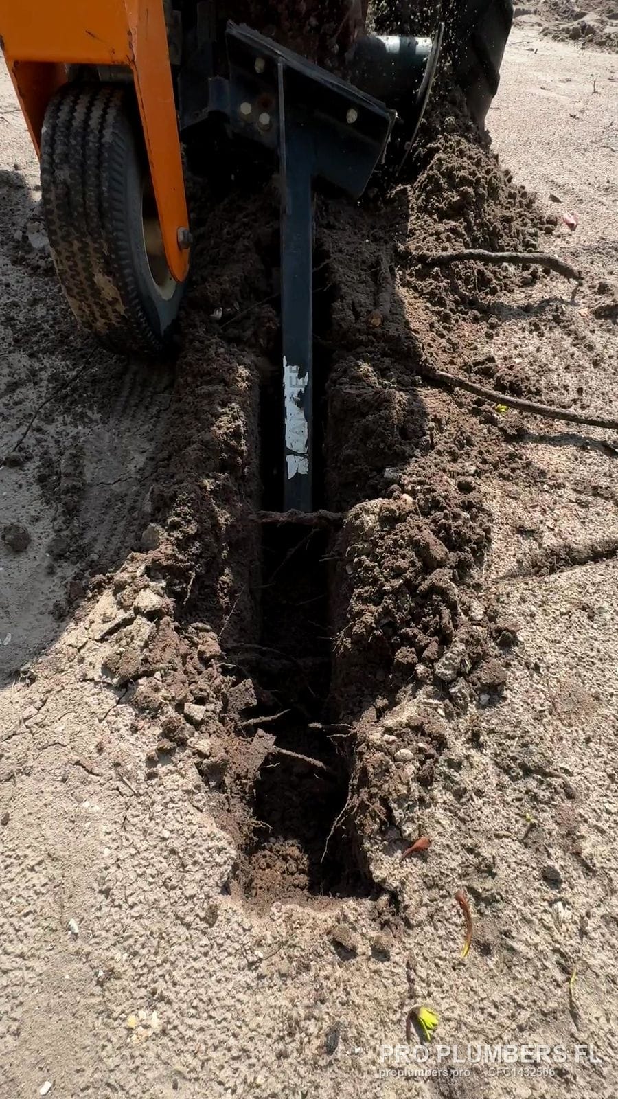 Walk-behind trencher cutting an irrigation line trench in sandy soil in Ruskin, Florida by PRO PLUMBERS FL, LLC (licence CFC1432506)