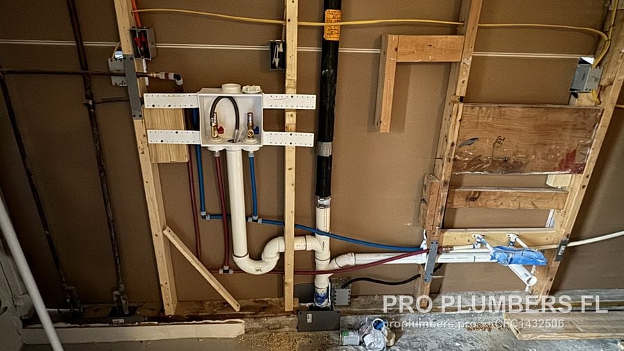 Washer outlet box with PVC drain and PEX supply across open wall studs in Hudson, Florida by PRO PLUMBERS FL, LLC (licence CFC1432506)