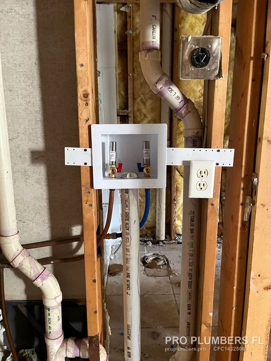 Washer outlet box with PVC standpipe and trap in an open stud wall next to an outlet in Clearwater, Florida by PRO PLUMBERS FL, LLC (licence CFC1432506)