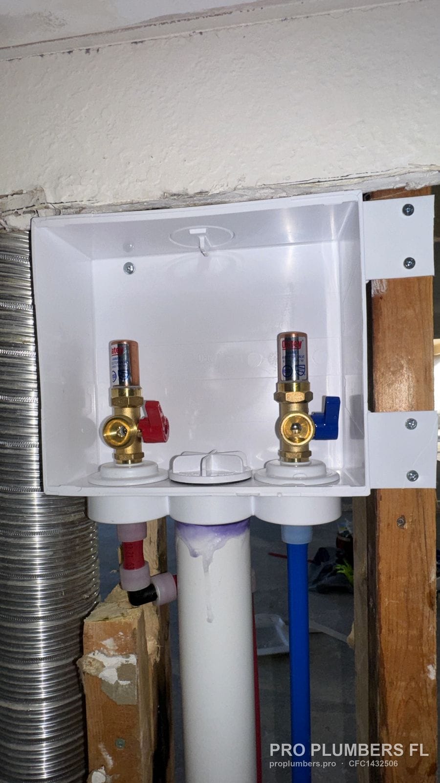 Close-up of a recessed washer outlet box with brass hot and cold valves in Pinellas Park, Florida by PRO PLUMBERS FL, LLC (licence CFC1432506)