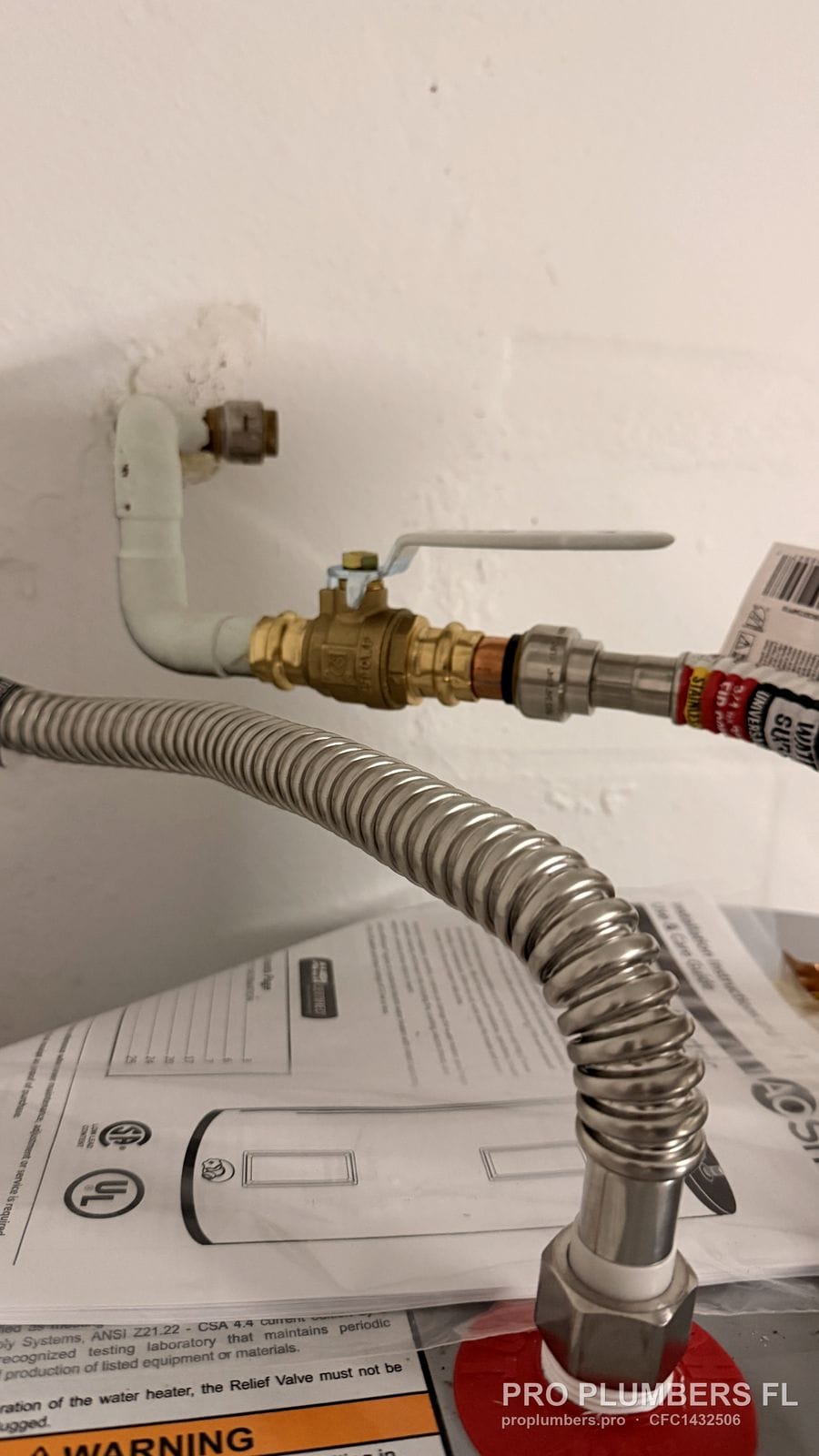 Ball valve and corrugated flex connector at the cold inlet of an electric water heater in Largo, Florida by PRO PLUMBERS FL, LLC (licence CFC1432506)