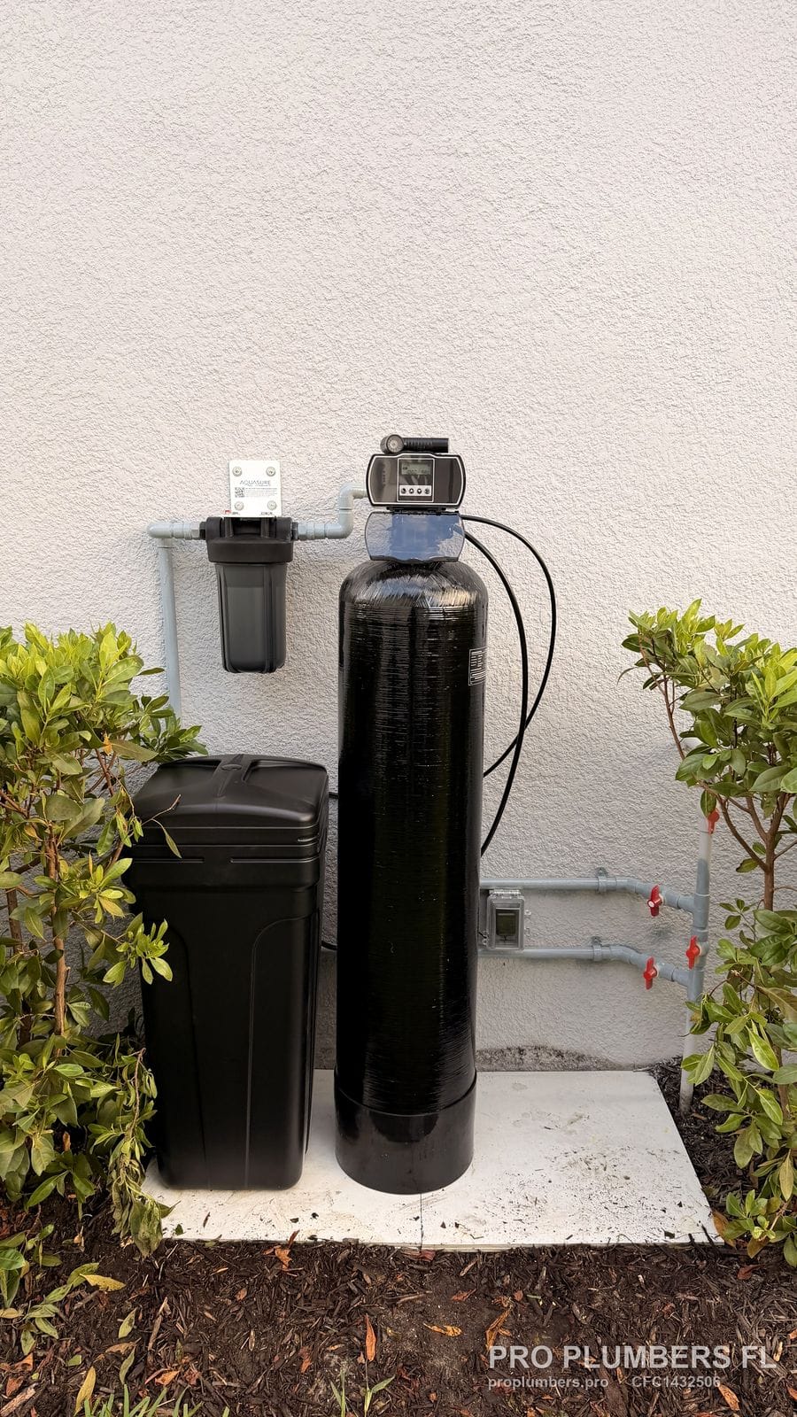 Finished water softener installation with painted supply piping, prefilter and bypass valves in Sarasota, Florida by PRO PLUMBERS FL, LLC (licence CFC1432506)